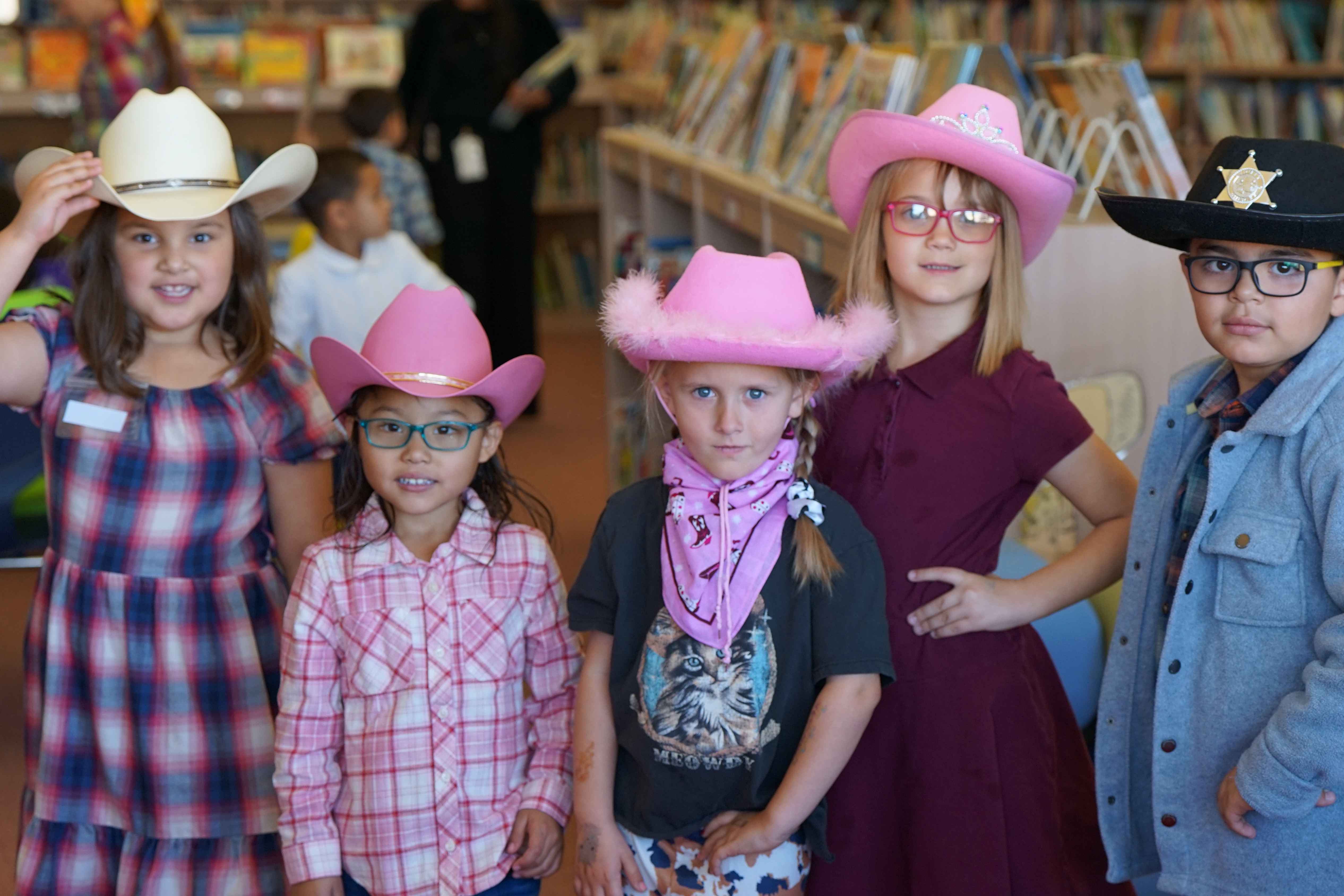 Five students show off their cowboy hats