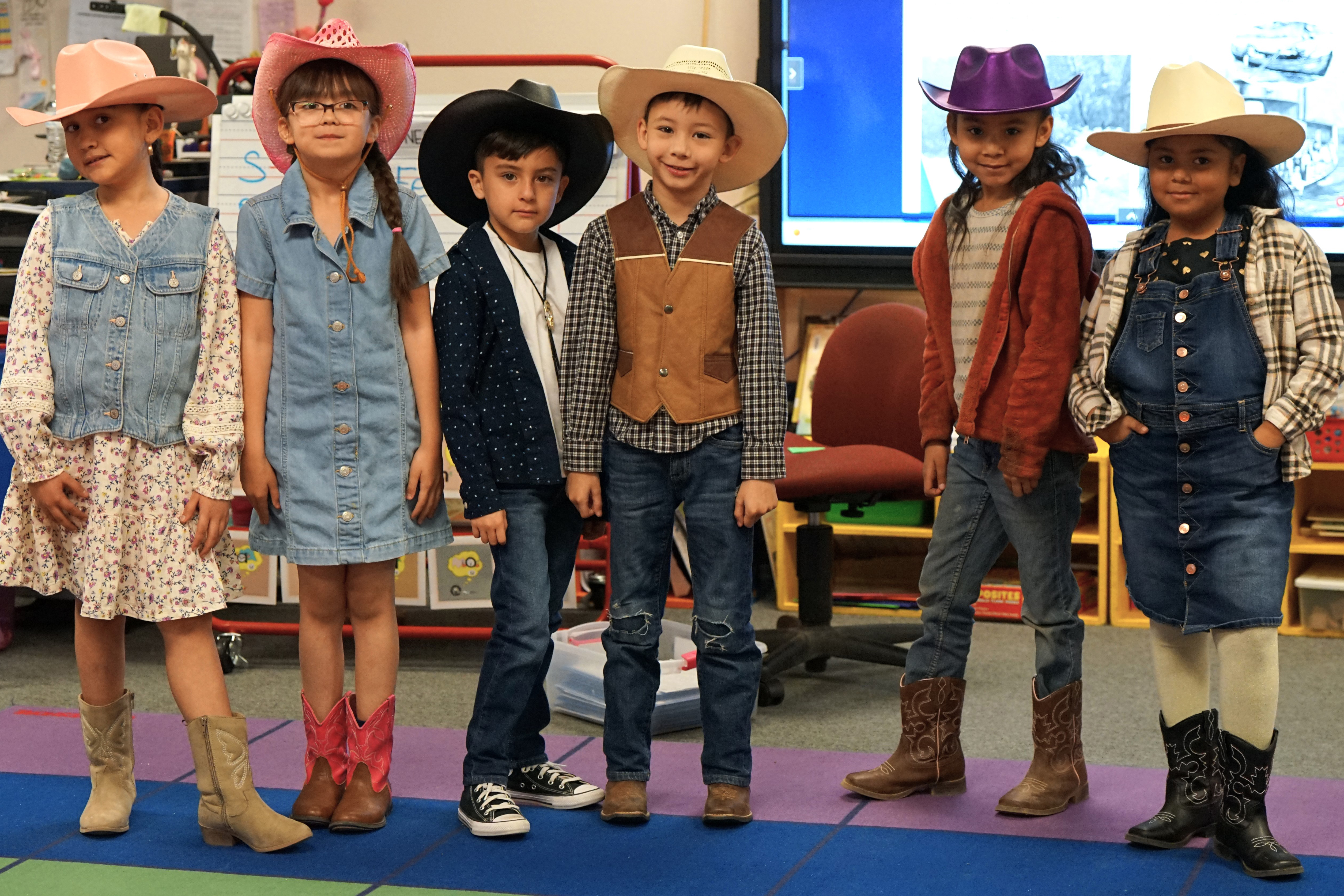 A group of students show off their rodeo gear