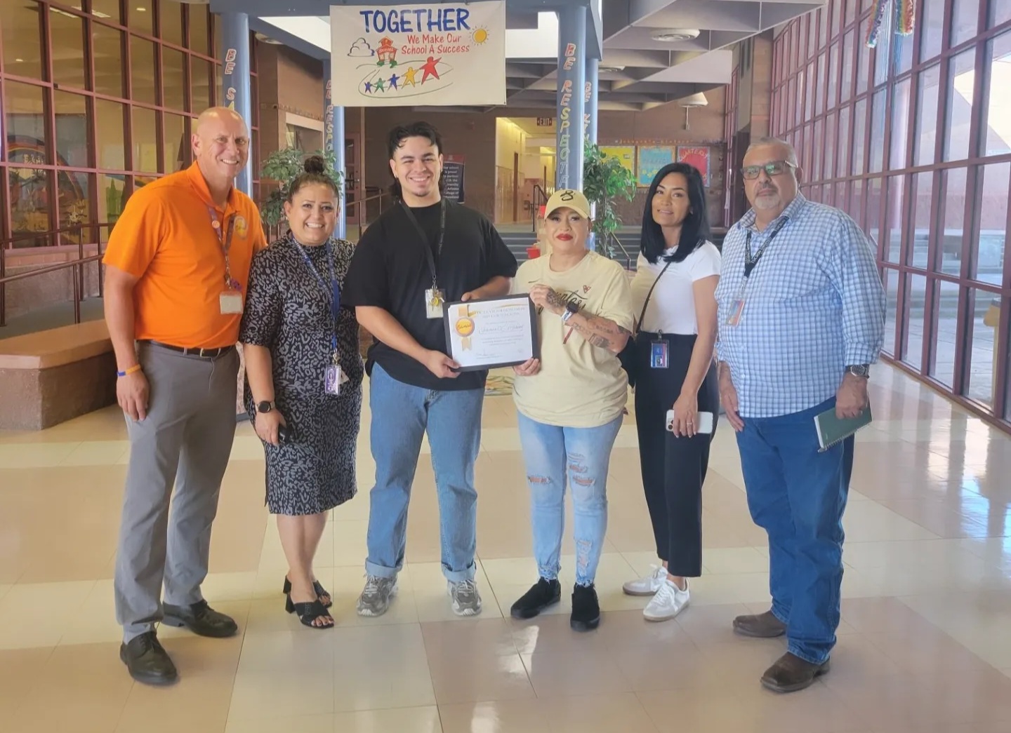 Johnson's custodial staff poses with their award certificate