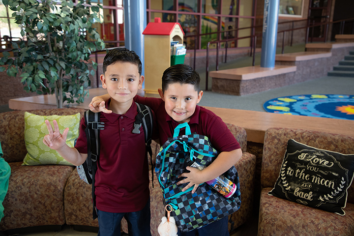 Two young boys with their arms around each other