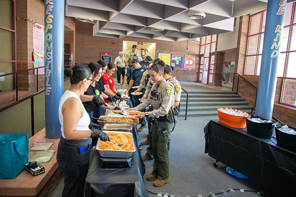 School staff serve lunch to the first responders
