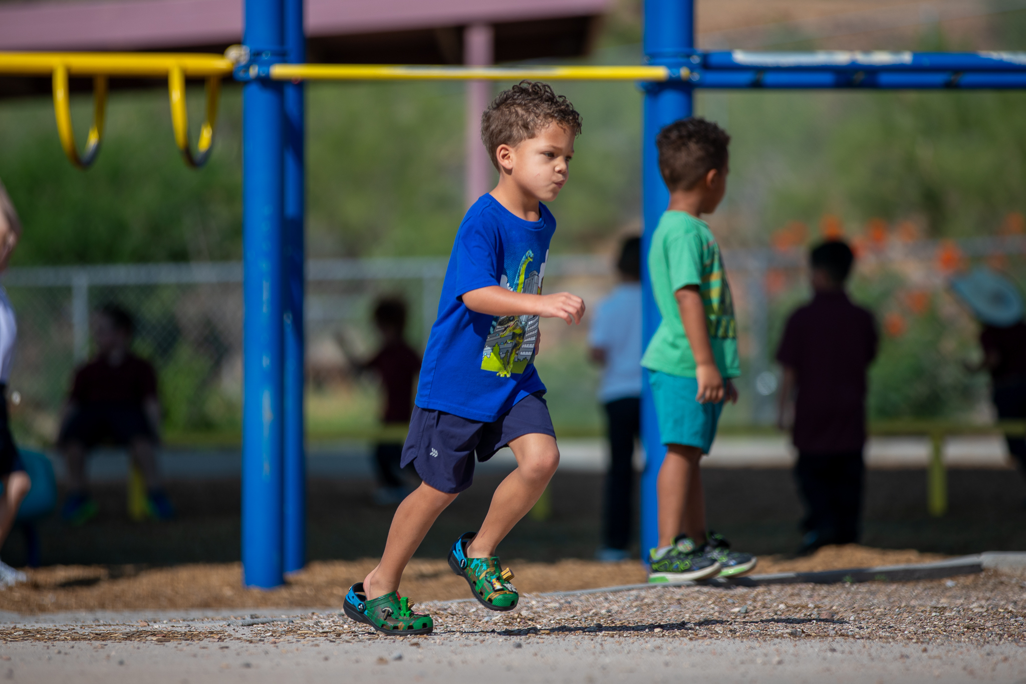 A boy runs around on the playground